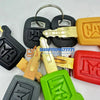 A collection of 55 replacement ignition keys for Caterpillar excavators in various colors and styles.