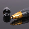 A close-up view of an adjustable high-pressure car wash water gun with a gold nozzle and black body, reflecting on a dark sur