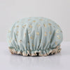 Light blue reusable elastic shower cap decorated with gold heart patterns