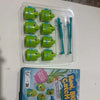 A clear plastic tray holds several green fishing game pieces and blue telescoping fishing rods.
