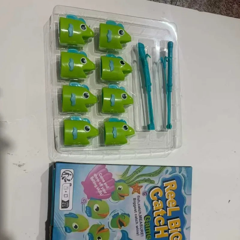 A clear plastic tray holds several green fishing game pieces and blue telescoping fishing rods.