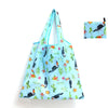 Light blue reusable shopping tote bag featuring a pattern of birds and flowers.