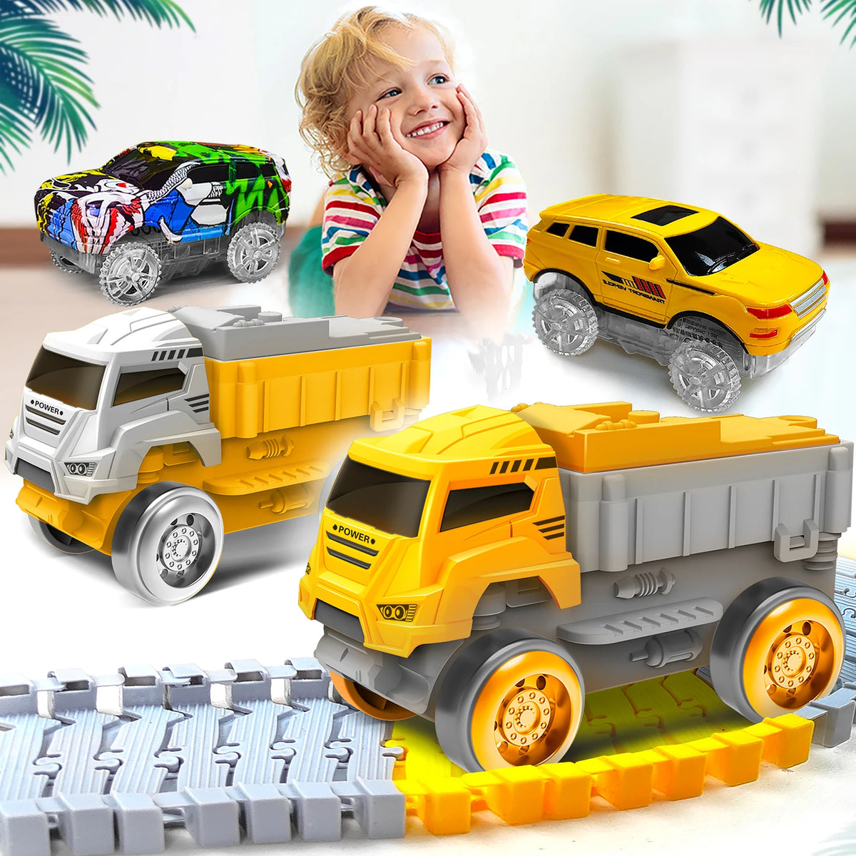 A yellow and gray toy truck is shown driving on a plastic track set with a smiling child in the background.