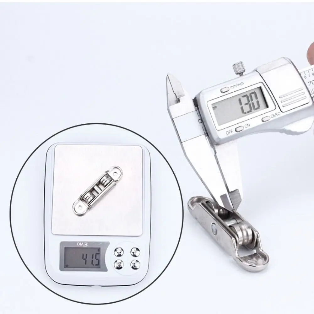 A close-up view of a stainless steel sliding door roller pulley device with an electronic display.