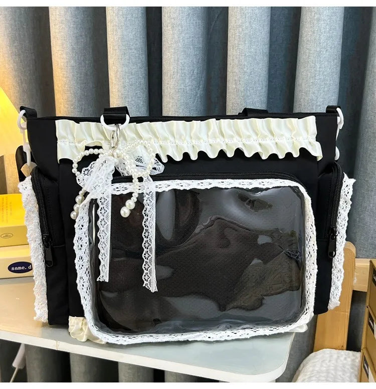 Black shoulder bag with white lace trim and a clear transparent front panel