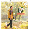 A man is walking a golden retriever on a pet traction rope in a park setting.