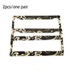 Two racing style license plate frames with a marbled black and gold pattern.