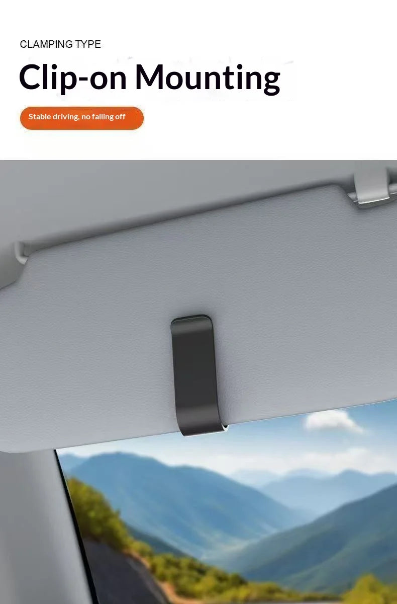 A close-up view of a black clip-on mounting system for holding glasses on a car window.