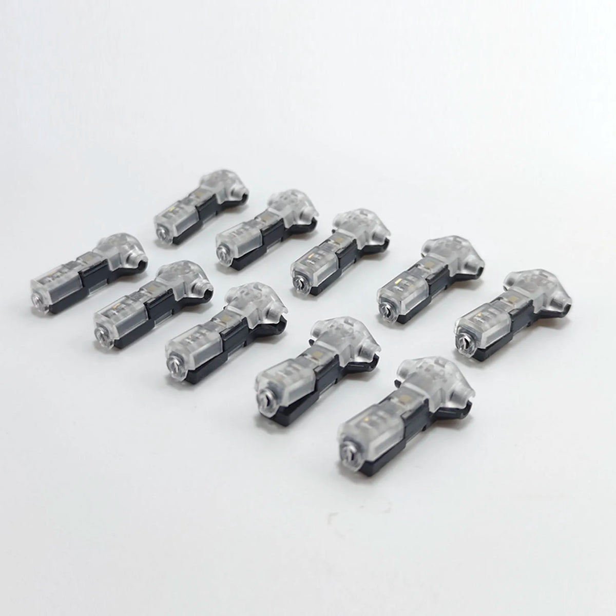 A collection of black and silver quick solderless wire tap connectors for low voltage applications.