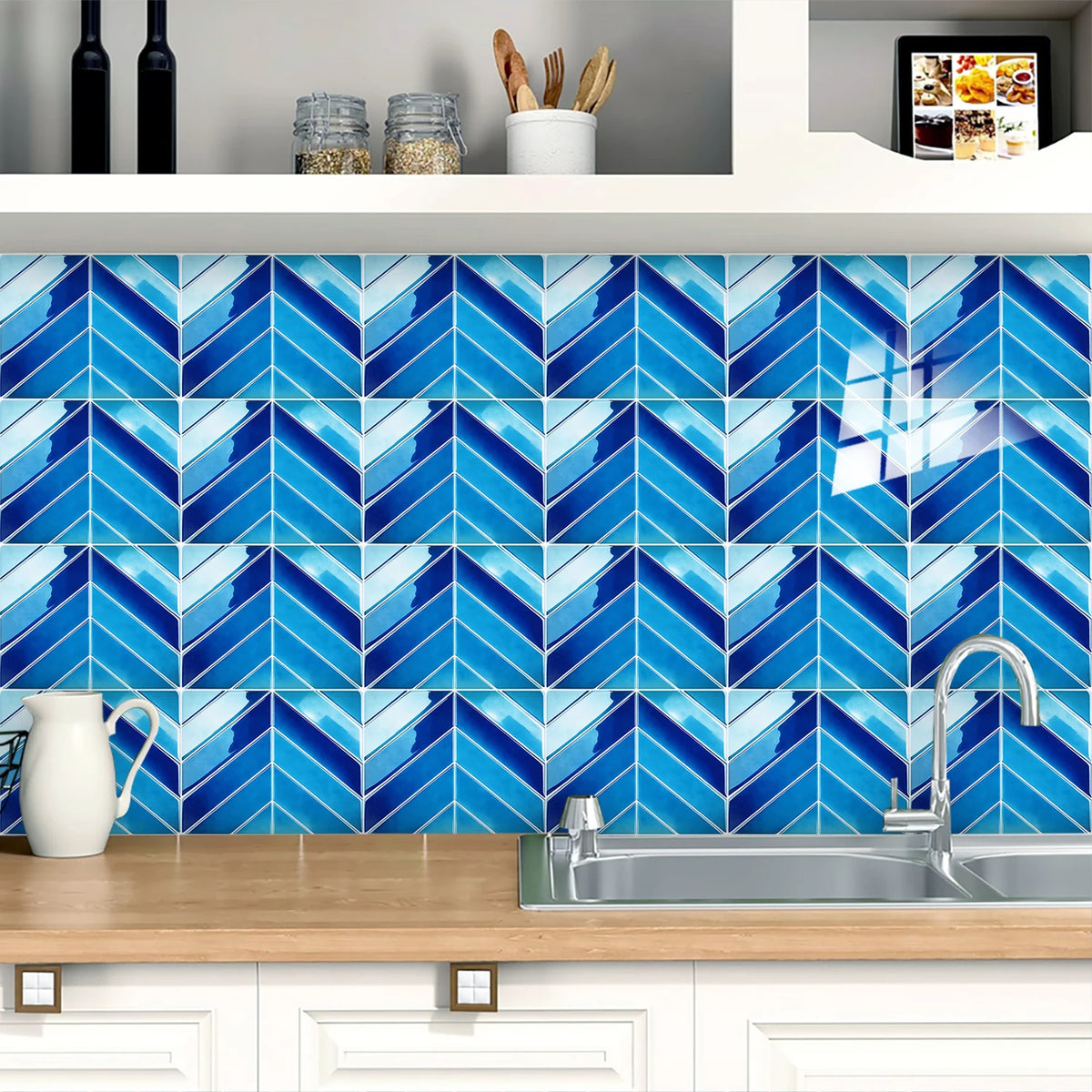 Blue and white herringbone marble peel-and-stick wall tiles installed on a kitchen backsplash.
