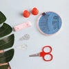 A kit for 64-color sewing thread with a portable storage case and measuring tools on a white background.