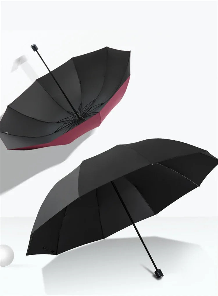 A black and red oversized folding umbrella is shown open against a white background.