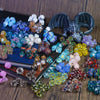 A collection of colorful polyhedral dice, including d20s and other shapes, displayed on a wooden surface.