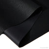 Black self-adhesive faux leather sheets rolled and displayed on a surface.
