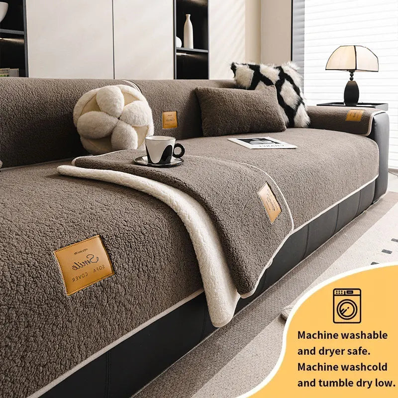 A cozy anti-slip lamb fleece sofa mat in beige and gray is shown on a dark sofa.