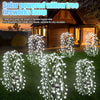 Solar powered willow tree fireworks lamp featuring multiple LED beams illuminating a garden.