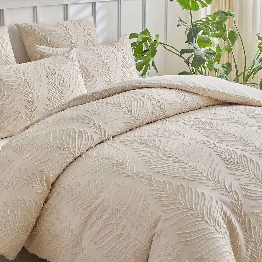 A beige embossed leaf pattern microfiber duvet cover set on a bed with green foliage in the background.