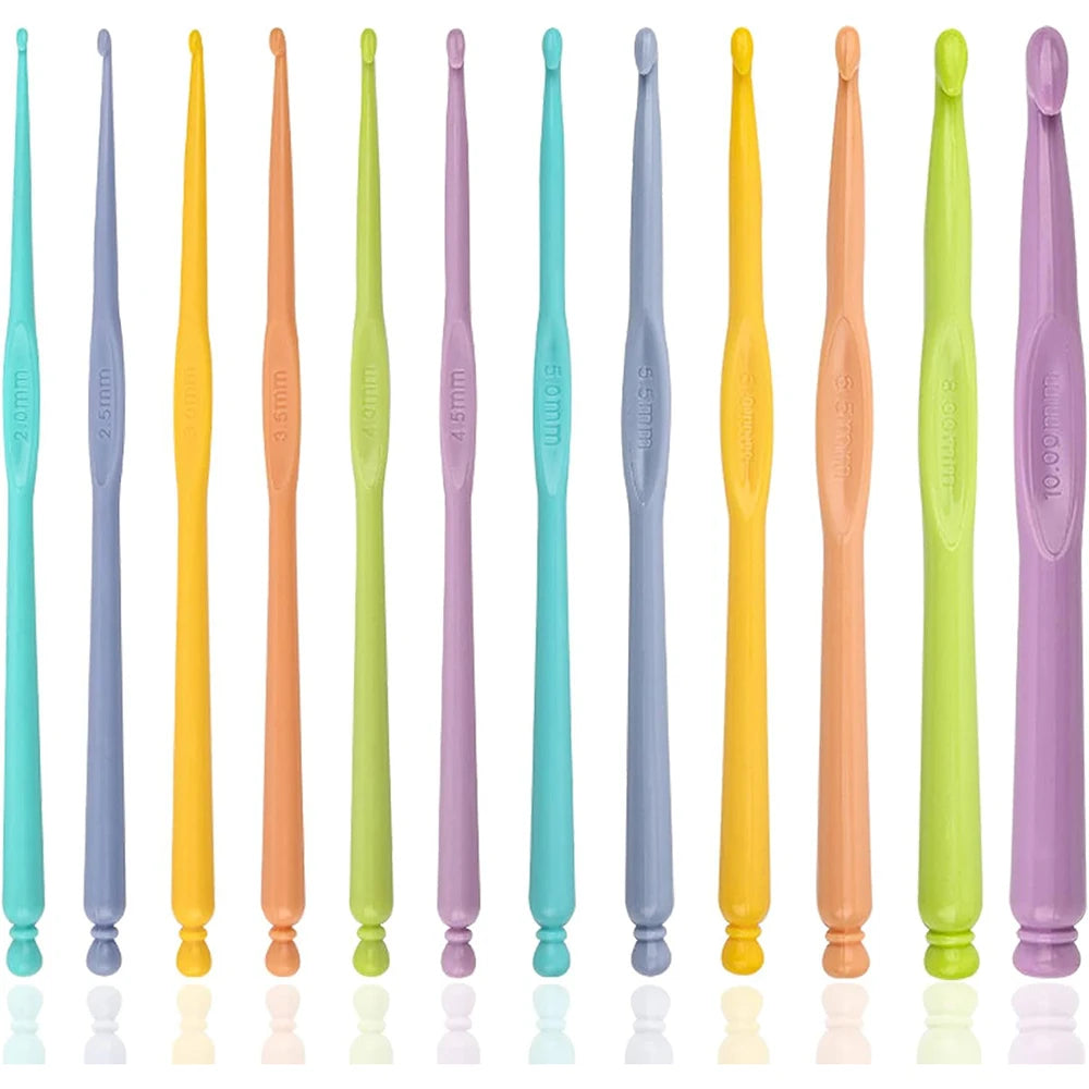 A set of twelve colorful plastic crochet hooks in various sizes and colors displayed in a row.