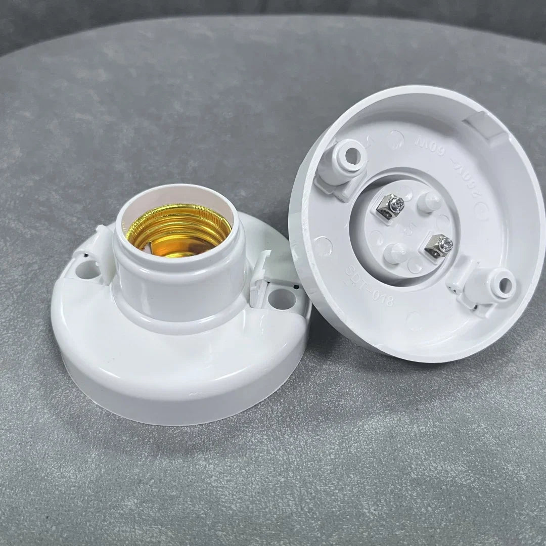 A white E27 screw cap light bulb holder with a gold-colored socket and a matching plastic cap.