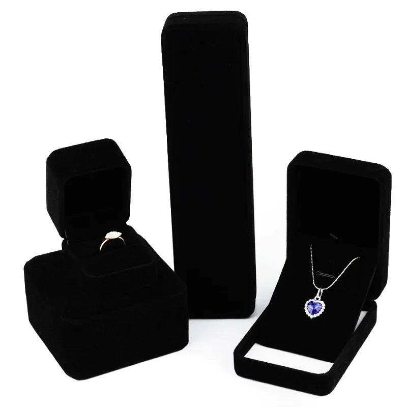 Elegant black velvet jewelry storage and gift box with a hinged lid displayed on a white background.