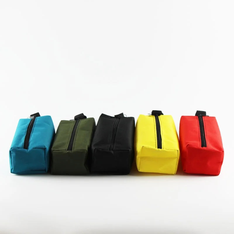 A row of five compact tool organizer bags in teal, olive green, black, yellow, and red.