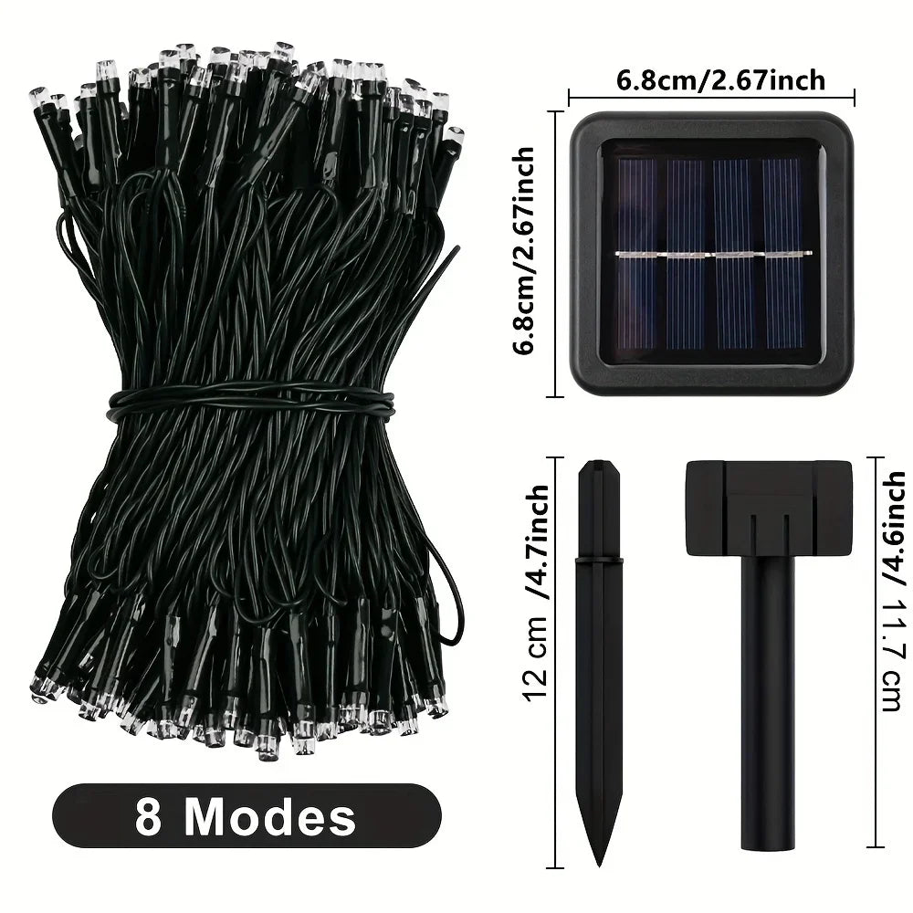 A bundle of black solar powered outdoor string lights with a rectangular panel and a separate light head.