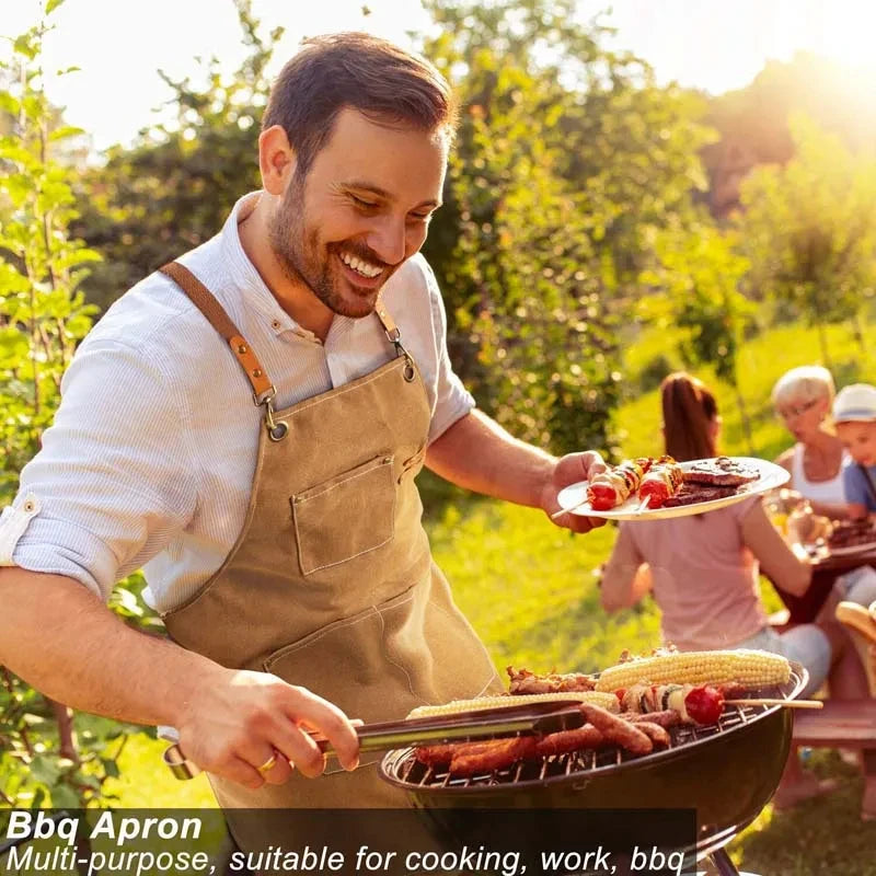 A man wearing a tan oil-proof canvas apron is grilling food outdoors in a sunny garden setting.