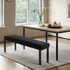 A black stretch jacquard bench cover is shown on a wooden table in a bright room.