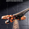 A close-up of an RC flying sword model being launched, showing the orange and black components against a dark background.