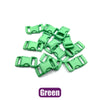 A pile of green plastic side-release buckles for paracord bracelet projects.