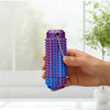 A hand holds a purple spiky sensory fidget roller with a silver chain, demonstrating its texture and design.