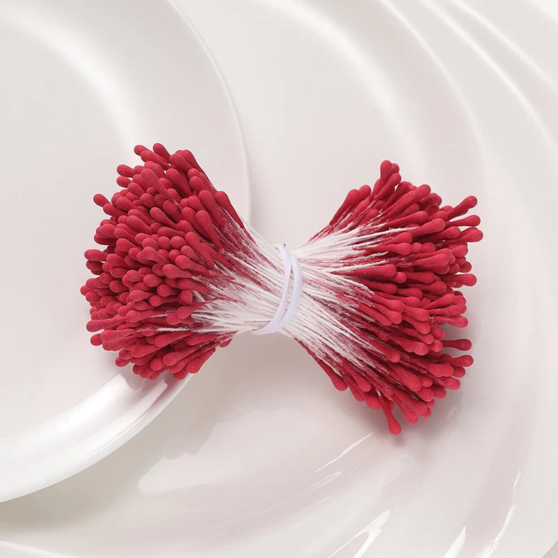 A bundle of 400 pearl flower stamens in deep red and white are displayed on a white plate.