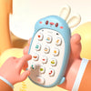 A hand holds a light blue rabbit-shaped baby music phone toy with a keypad and teether on a wrist.