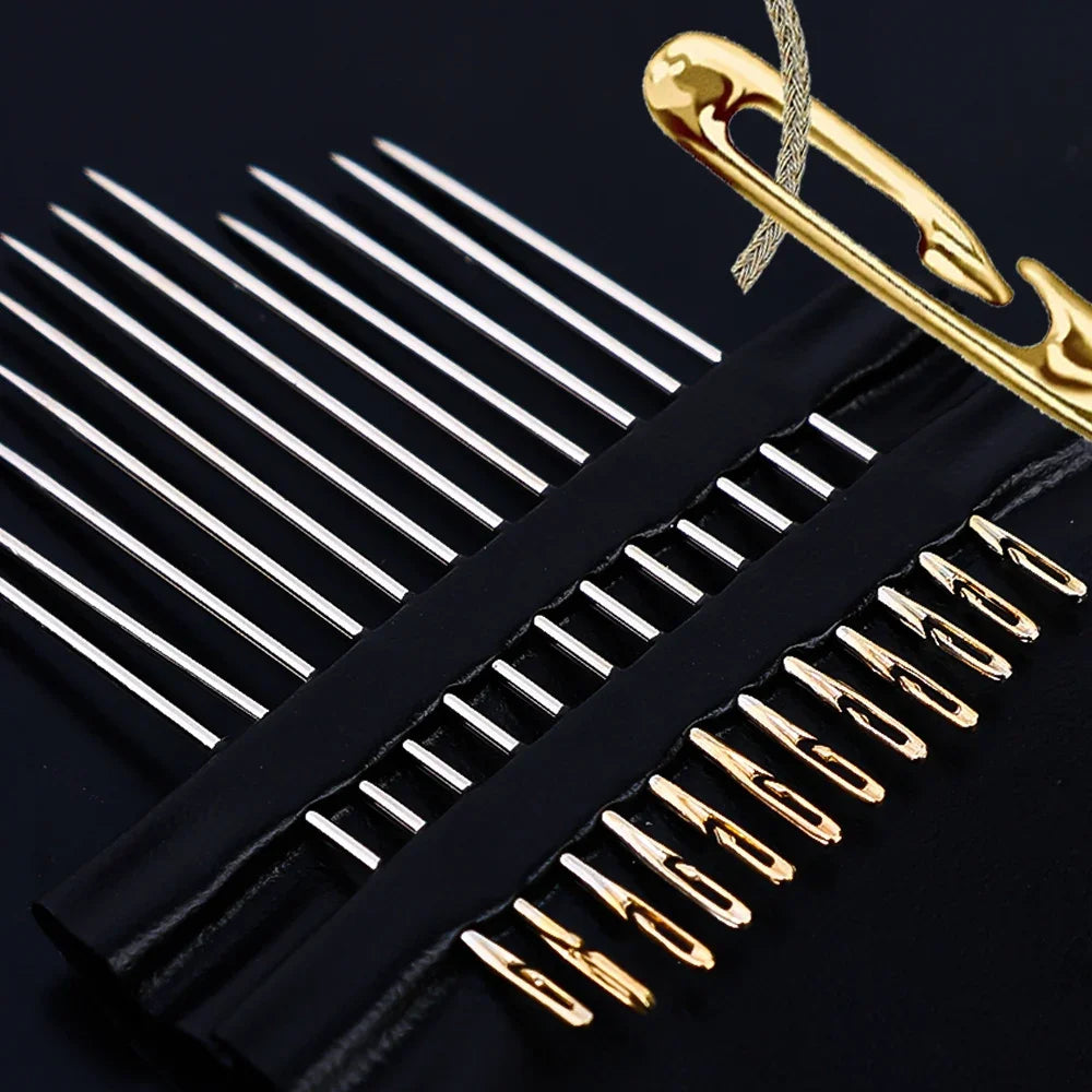 A set of gold-tipped stainless steel self-threading sewing needles is shown against a black background.