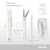 A white pen-shaped tool featuring scissors and a ruler, shown with various components and packaging.