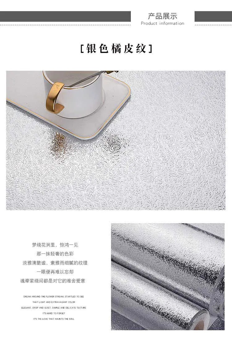 Close-up of brushed silver peel-and-stick metal wallpaper texture on a surface.