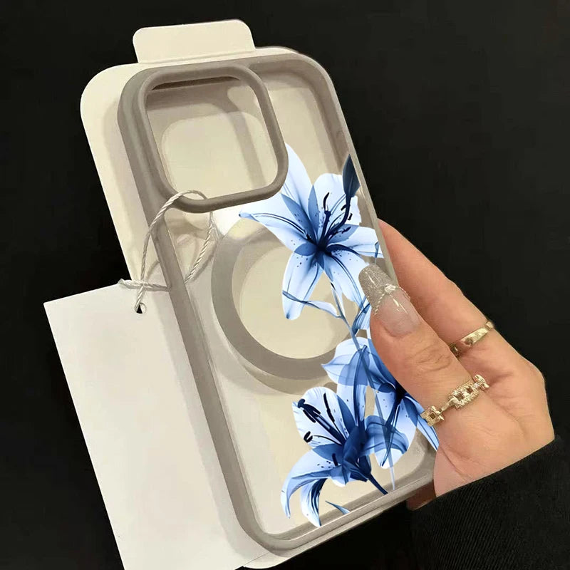 A hand holds a blue lily patterned magnetic phone case with a matte clear finish.