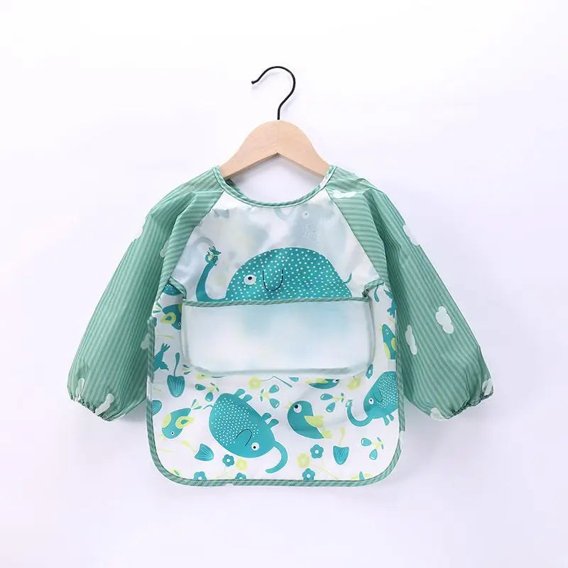 A light green waterproof long-sleeve baby feeding smock with a pattern of blue sea creatures.
