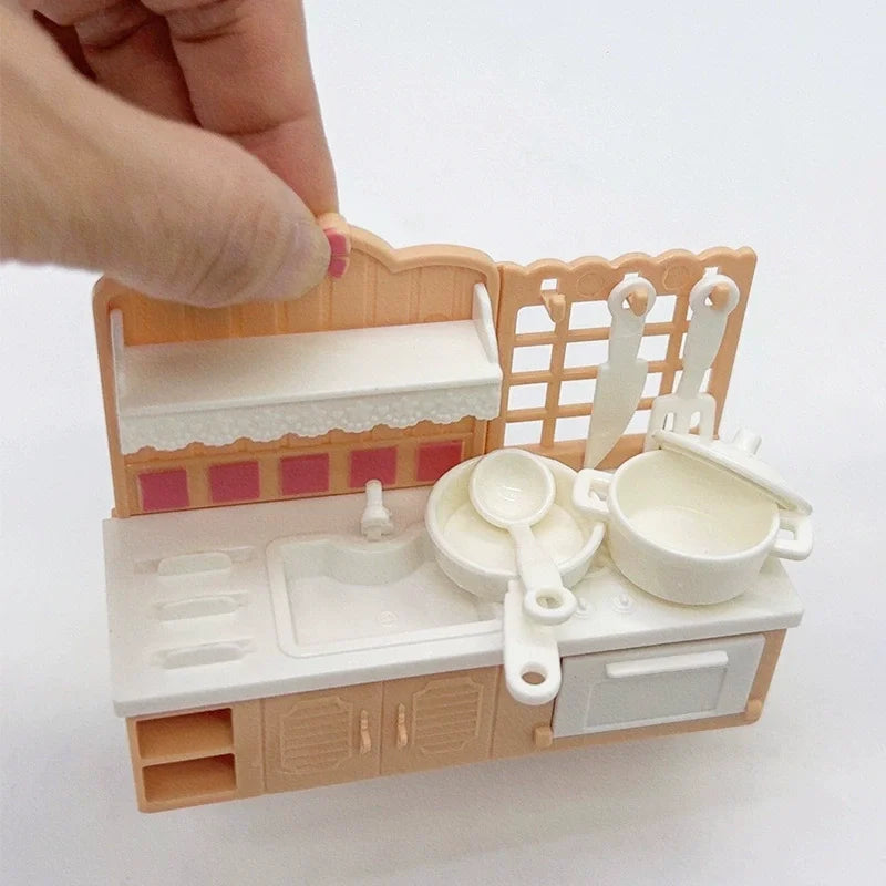A miniature dollhouse furniture set featuring a wooden kitchen and bathroom area with white porcelain accessories.