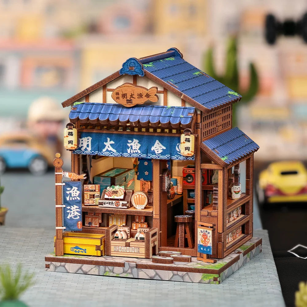 A detailed miniature wooden book nook kit depicting a traditional Japanese shop with a tiled roof and display windows.