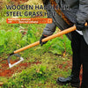 A person holds a wooden handle steel grass hoe for weeding in a garden setting.