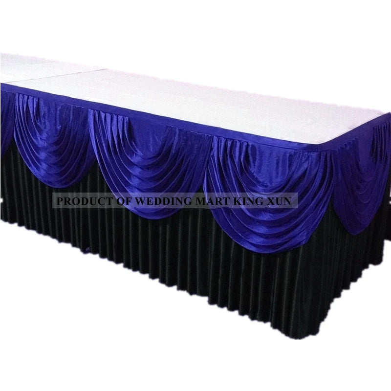 Elegant ice silk table skirt in royal blue with ruffled fabric and matching top swag.