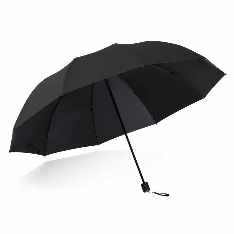 A black oversized folding umbrella is shown open against a white background.