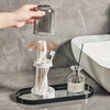 A hand pours water into a modern bathroom toothbrush holder with a dust cover and drainage.