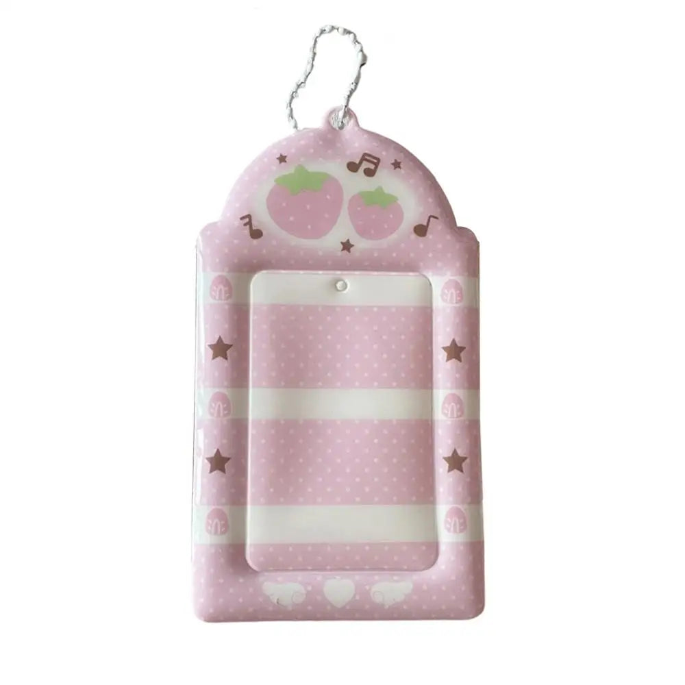 Pink strawberry card holder keychain with a rounded, padded design and a hanging loop.