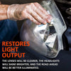 A hand wearing a glove is polishing a clear plastic headlight lens to restore light output.
