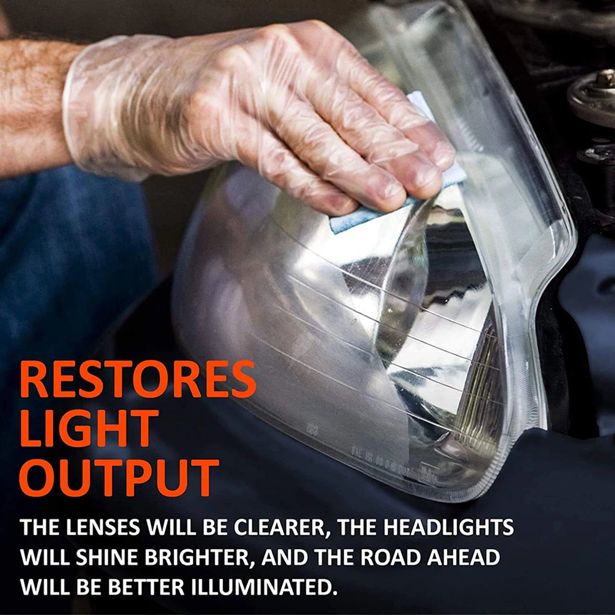 A hand wearing a glove is polishing a clear plastic headlight lens to restore light output.