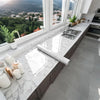 A kitchen countertop with a marble peel-and-stick backsplash film and a stainless steel sink.