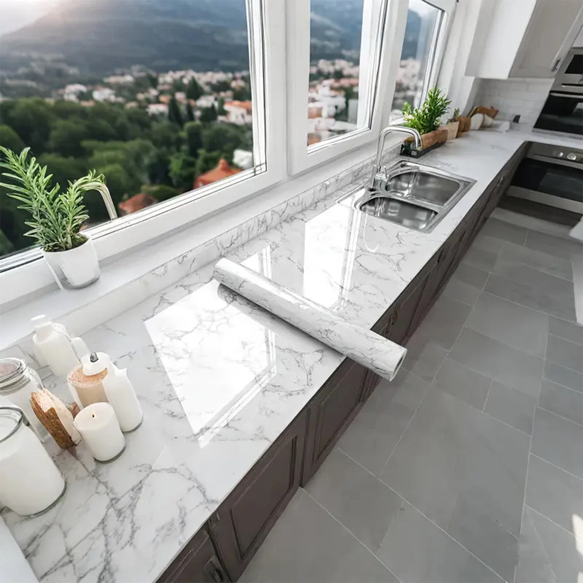 A kitchen countertop with a marble peel-and-stick backsplash film and a stainless steel sink.