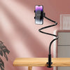 A black flexible stand holding a smartphone in a vertical position on a wooden desk.